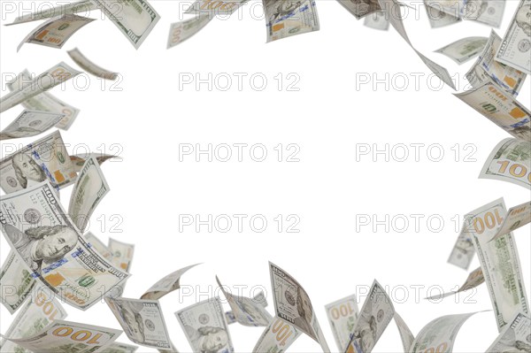 Border of falling one hundred dollar bills isolated on a white background