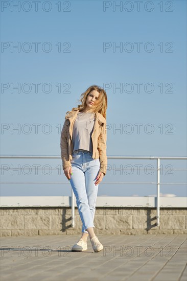 Young woman in casual clothes posing on the street