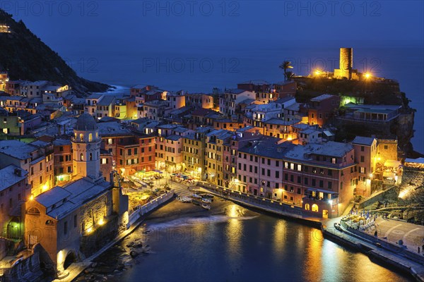 View of Vernazza village popular tourist destination in Cinque Terre National Park a UNESCO World Heritage Site, Liguria, Italy view illuminated in the night from Azure trail