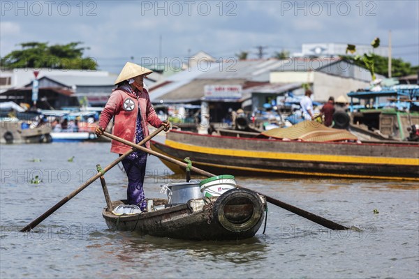 CAN THO, VIETNAM, 4 JUNE, 2011: Unidentified woman at floating market in Mekong river delta. Cai Rang and Cai Be markets are central markets in delta and became popular tourist destination