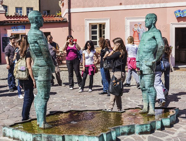 PRAGUE, CZECH REPUBLIC, APRIL 28, 2012: Bizarre peeing men sculpture by David Cerny in Prague, Czech republic surrounded by tourists