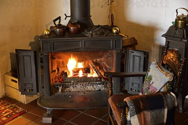 Europe, Germany, fireplace, stove, type Franklin, in living room, chair by the fireplace, Hamburg, Hamburg, Federal Republic of Germany, Europe