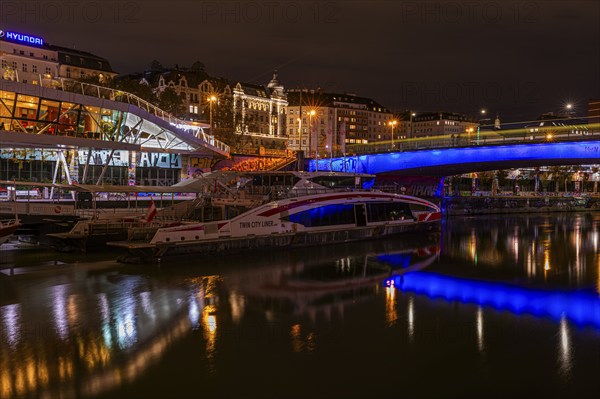 Ferry anchored in the Danube Canal, behind the illuminated Franz-Josefs Quay and St Mary's Bridge, night shot, Vienna, Austria, Europe