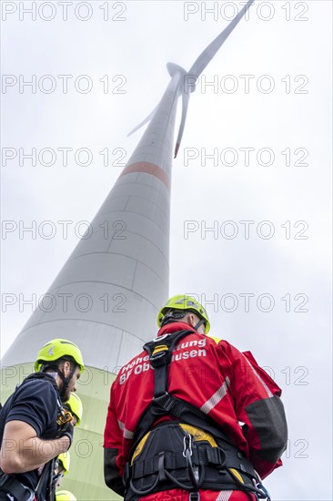 Height rescuers from the Oberhausen fire brigade practise abseiling from a wind turbine from a height of 150 metres, briefing on the turbine, in rainy weather, Issum, North Rhine-Westphalia, Germany, Europe