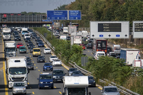 Traffic jam on the A3 motorway, over 8 lanes, in both directions, in front of the Leverkusen motorway junction, Friday afternoon high traffic volume, roadworks, gantry signs with journey times, delays due to the traffic jam, Leverkusen, North Rhine-Westphalia, Germany, Europe