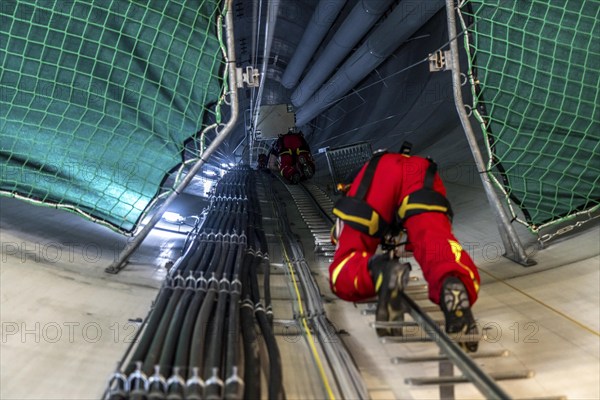 Height rescuers from the Oberhausen professional fire brigade practise abseiling from a wind turbine from a height of 150 metres, ascent into the turbine, to the nacelle, Issum, North Rhine-Westphalia, Germany, Europe