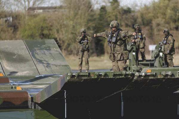 An engineer soldier stands on an amphibious vehicle of the type Amphibie M3 of the Bundeswehr, taken during the military exercise 'Wettiner Schwert' near Tangermünde, 26.03.2024. 'Wettiner Schwert' is part of the Quadriga exercise of the Bundeswehr and the NATO large-scale manoeuvre Steadtfast Defender 2024