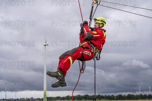 Height rescuers from the Oberhausen fire brigade practise abseiling from a wind turbine from a height of 150 metres after rescuing an accident victim from the nacelle, Issum, North Rhine-Westphalia, Germany, Europe