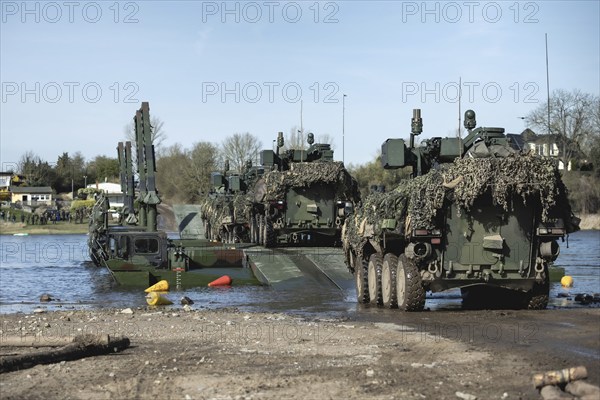 Pandur wheeled tanks of the Czech army drive onto German Bundeswehr vehicles of the Amphibie M3 type as part of the multinational military exercise 'Wettiner Schwert' near Tangermünde, 26.03.2024. 'Wettiner Schwert' is part of the Quadriga exercise of the Bundeswehr and the NATO large-scale manoeuvre Steadtfast Defender 2024