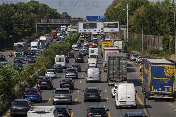 Traffic jam on the A3 motorway, over 8 lanes, in both directions, in front of the Leverkusen motorway junction, Friday afternoon high traffic volume, roadworks, gantry signs with journey times, delays due to the traffic jam, Leverkusen, North Rhine-Westphalia, Germany, Europe