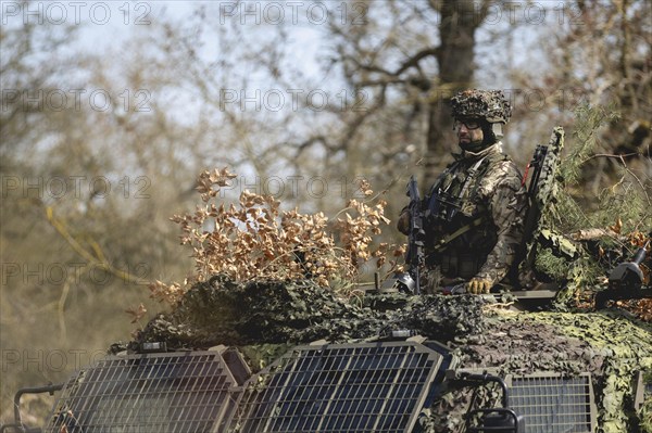 A Czech soldier occupies the hatch of an armoured vehicle as part of the military exercise 'Wettiner Schwert' near Tangermünde, 26.03.2024. 'Wettiner Schwert' is part of the Quadriga exercise of the German Armed Forces and the NATO large-scale manoeuvre Steadtfast Defender 2024