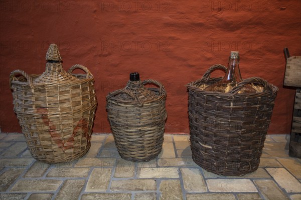 Old basket bottles for storing rum in the rum museum in Flensburg, Schleswig-Holstein, Germany, Europe