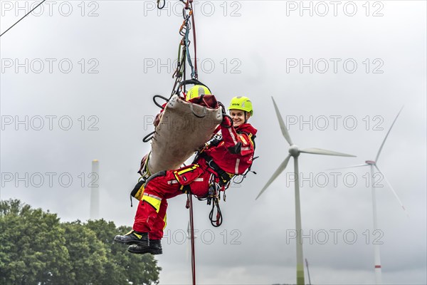 Height rescuers from the Oberhausen professional fire brigade practise abseiling from a wind turbine from a height of 150 metres, rescuing an injured person, technician, from the nacelle, Issum, North Rhine-Westphalia, Germany, Europe