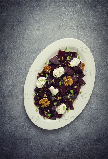 Beetroot salad with nuts, cream cheese and micro greenery, homemade, no people