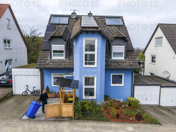 Detached house with various solar modules, in addition to normal standard solar panels, PV tube collectors are also installed, plug-in solar modules are mounted on a dustbin box as a roof, Essen, North Rhine-Westphalia, Germany, Europe