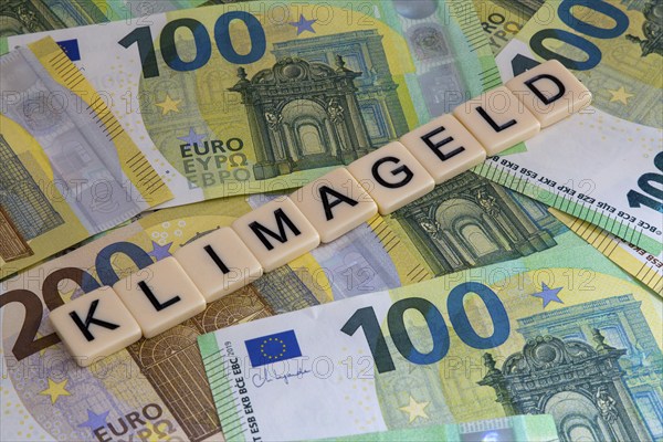 Symbolic image of climate money: Letters on euro notes display the word climate money