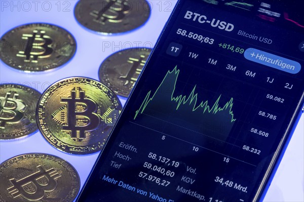 Bitcoin cryptocurrency, symbol coin, mobile phone, mobile phone with Bitcoin exchange rates, to the euro, optical placeholder for the digital currency, blockchain, stock exchange rates