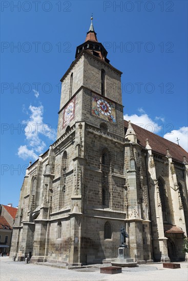 Gothic church with tower under clear blue sky, large clock visible, Black Church, Old Town, Brasov, Brasov, Transylvania, Romania, Europe