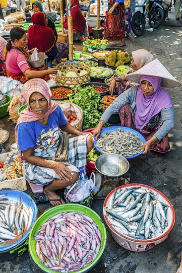 Traditional authentic food market, vendor, woman, fruit, vegetable, fish, fresh, food, nutrition, sale, trade, bazaar, authentic, disease vector, food law, food control, stall, Asian, vegetable market, local, hygiene, virus, tradition, traditional, health, marketplace, market hall, tropical, travel, tourism, culture, poverty, presentation, cleanliness, person, Muslim, Islam, Lombok, Indonesia, Asia