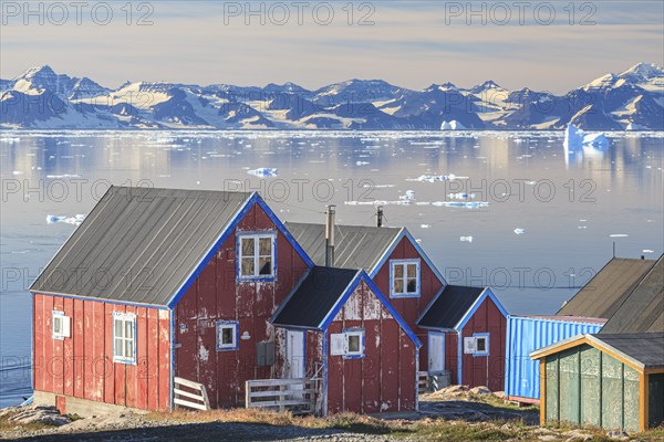 Typical Greenlandic house in an Inuit settlement on a fjord off Bergen, sunny, Ittoqqortoormiit, Scoresby Sund, East Greenland, Greenland, North America