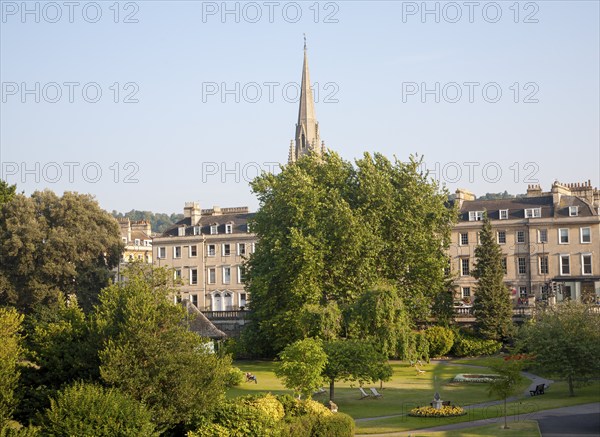 Parade Gardens public park in city centre of Bath, Somerset, England with church spire in background