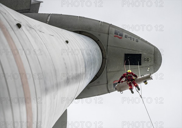 Height rescuers from the Oberhausen professional fire brigade practise abseiling from a wind turbine from a height of 150 metres, rescuing an injured person, technician, from the nacelle, Issum, North Rhine-Westphalia, Germany, Europe