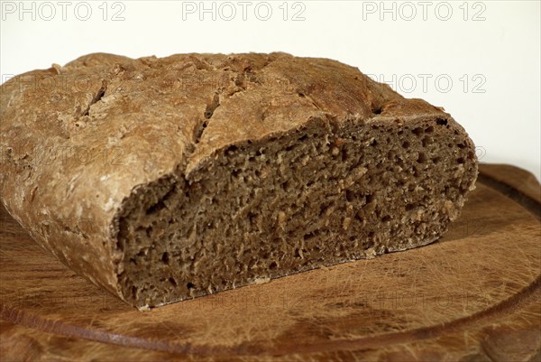 Bread loaf, grey bread, cut, on a wooden board