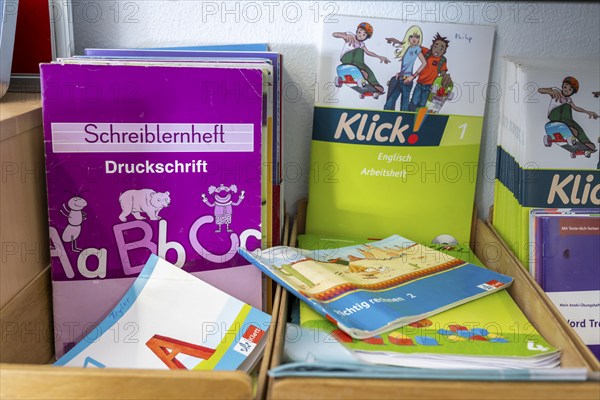 Classroom of a fourth grade, after school, the building is older but in good condition, textbooks, language