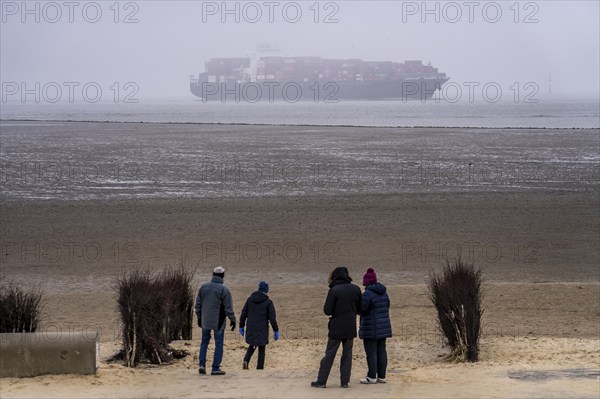 Thick fog in winter, hanging over the mouth of the Elbe into the North Sea, container ship NYK Venus, entering the Lower Elbe, Cuxhaven, Lower Saxony, Germany, Europe