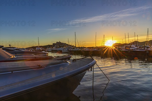 Luxury yachts under a low sun in the harbour of Eivissa, Ibiza Town, Ibiza, Balearic Islands, Mediterranean Sea, Spain, Europe