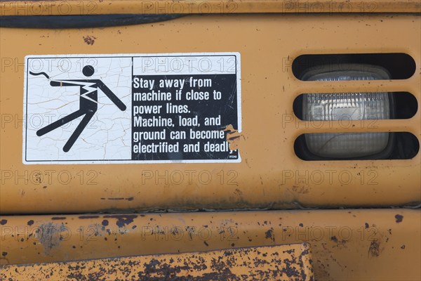 Pictogram and written danger warning sticker on heavy duty backhoe excavator, Quebec, Canada, North America