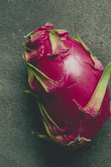 Dragon fruit, pitahaya, one piece, top view, rustic style, green background