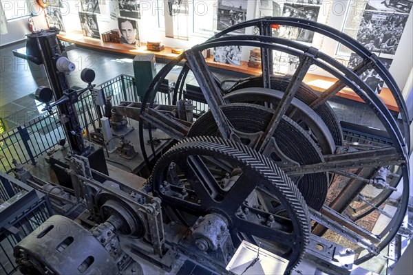 Winding engine with depth indicator to raise and lower lift cage in mine shaft at Le Bois du Cazier coal mine museum, Marcinelle, Hainaut, Belgium, Europe