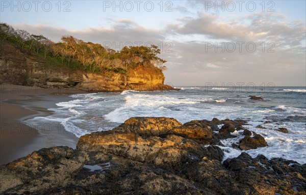 Sandy beach beach with rocks and sea at sunset, Playa Cocalito, coastal landscape, Pacific coast, Nicoya Peninsula, Puntarenas Province, Costa Rica, Central America