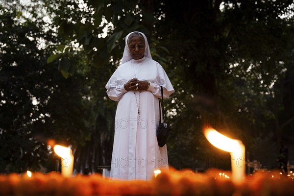 A Nun offer prayers on the grave during the All souls day observation, in Guwahati, India on 2 November 2024. All Souls' Day is a Christian holiday dedicated to honoring and praying for the souls of the departed