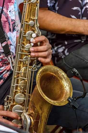 Saxophonist and group of musicians during a musical performance on the streets of Recife, Recife, Pernambuco, Brazil, South America