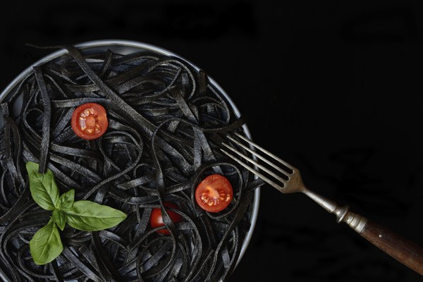 Black pasta coloured with squid ink and fork, Taglioni al Nero di Seppia, Italy, Europe