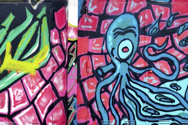 Graffiti of a blue octopus on a pink and green background, Landau, Rhineland-Palatinate, Germany, Europe