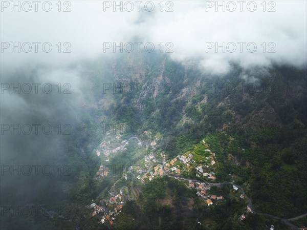 Aerial drone view of Curral das Freiras village in Valley of the Nuns from Miradouro da Eira do Serrado, Madeira island, Portugal, Europe