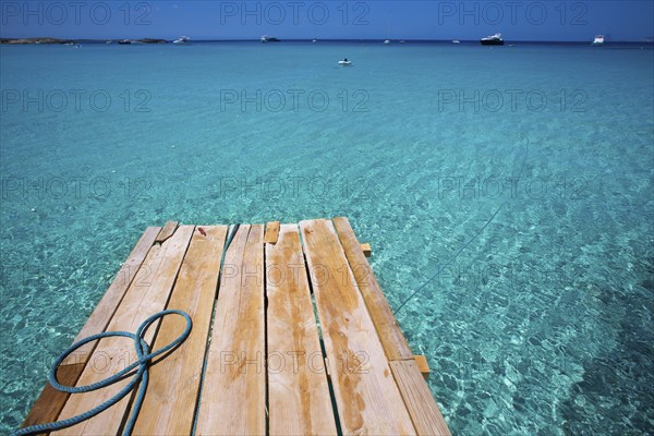 Formentera Ses Illetes beach pier Illetas with Ibiza background at balearic islands