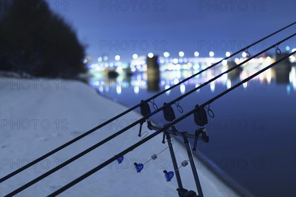 Carp spinning reel angling rods in winter night. Night Fishing, Carp Rods, Winter fishing