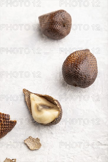 Salak or snake fruit on gray concrete background. Side view, close up. Tropical, healthy food, summer, exotic, minimalism