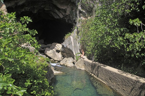 Person exploring entrance ot cave, Cueva del Gato, Benaojan, Serrania de Ronda, Malaga province, Spain, Europe