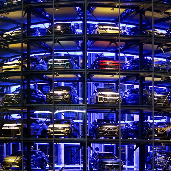 An illuminated car tower with new cars for delivery in the evening, detail, Autostadt, Volkswagen AG, Wolfsburg, Lower Saxony, Germany, Europe