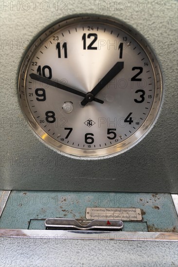 Mechanical time clock, analogue recording of working time, symbolic image