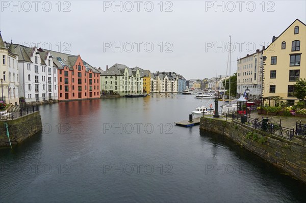 City view with coloured buildings by the sea, boats and bridge in the background, Alesund, Fylke, Norway, Europe