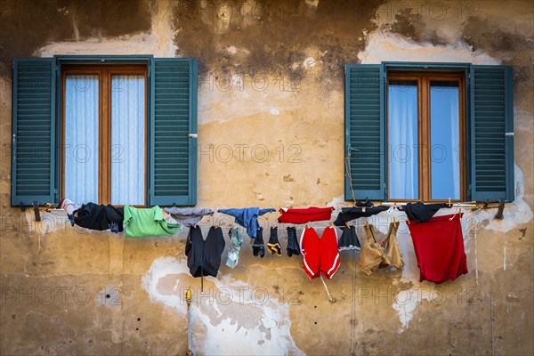 Colourful laundry for drying, dilapidated, clothesline, washing, house wall, Italy, Europe