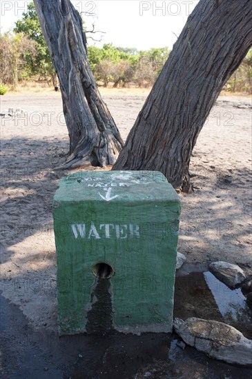 Secured waterhole against baboons, water, drinking water, security, waterhole, tap water, camping, adventure holiday in Savuti camp in the wilderness of Africa in Botswana