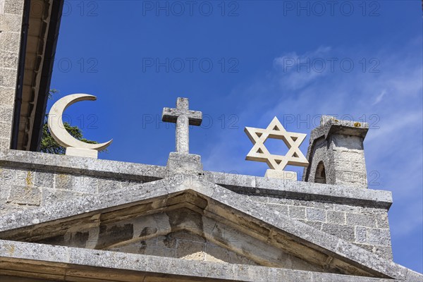 Cross of Christianity, crescent of Islam, Star of David of Judaism, Cappella Nuova historic building in San Marino. The symbols of the three monotheistic religions united