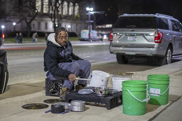 Detroit, Michigan - A street musician performs on his pots and pans on Noel Night. The annual event at the beginning of the holiday season in Detroit features open houses by arts and cultural institutions, churches, and small businesses.